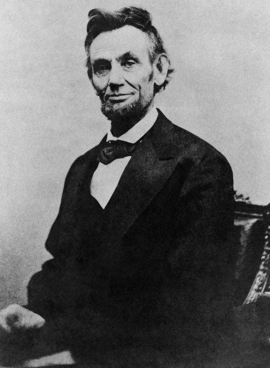 1200px-Abraham_Lincoln_half_length_seated,_April_10,_1865